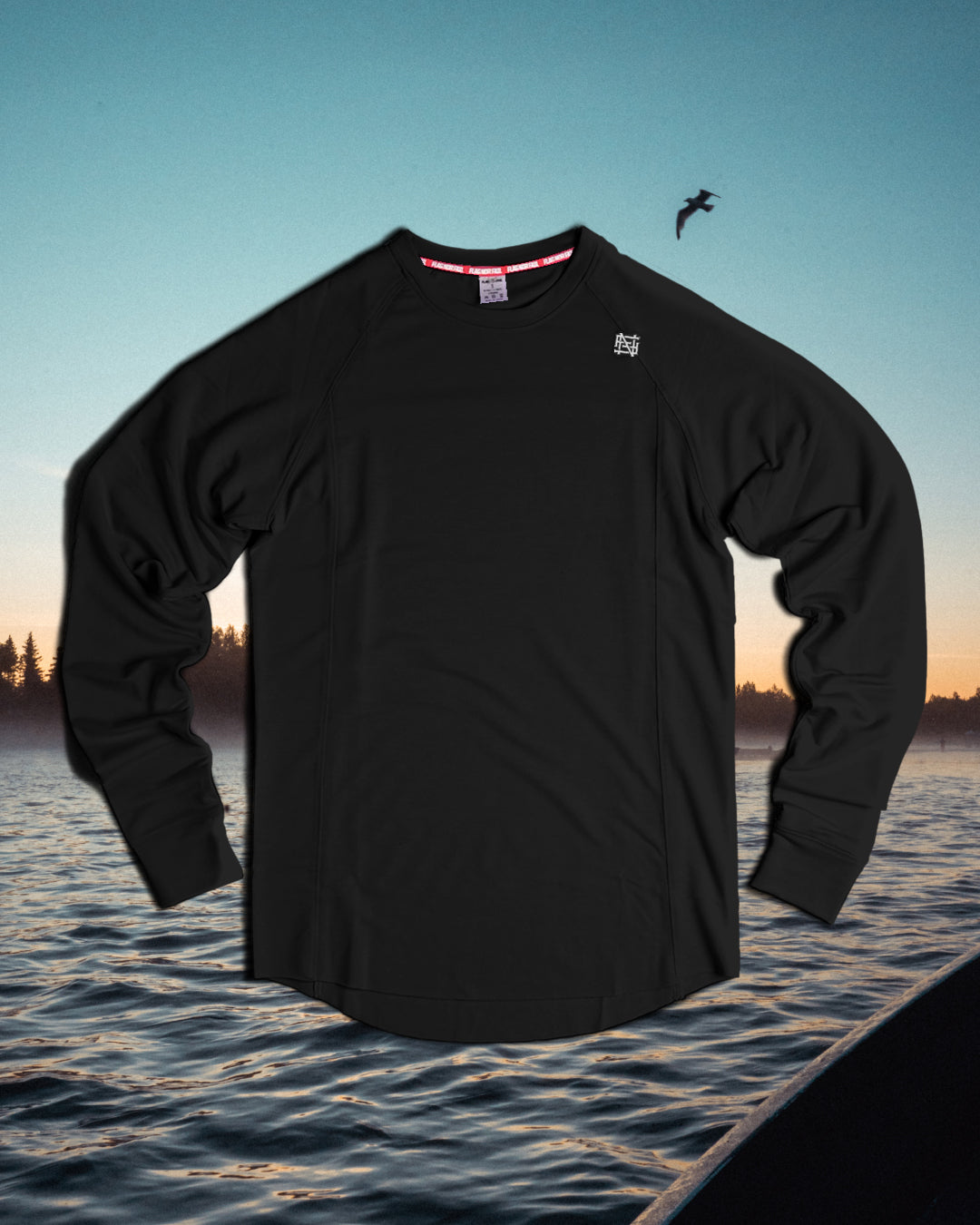 Black long-sleeve shirt with a brand logo on a background of water and sky.
