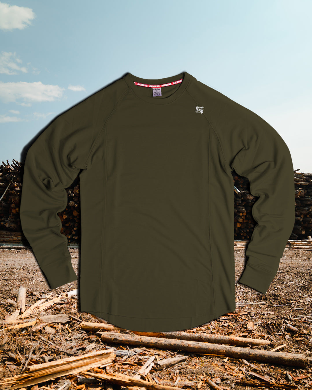 Green long-sleeve shirt on a wooden background