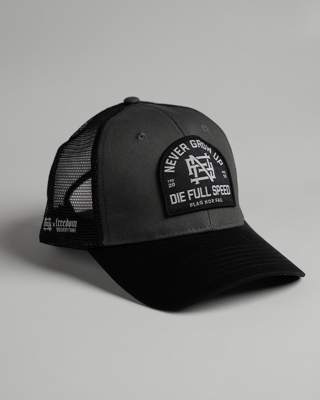 NEVER GROW UP TRUCKER HAT - BLACK