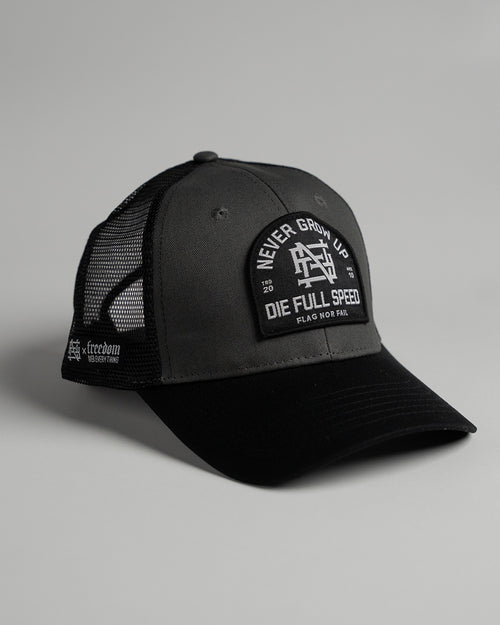 NEVER GROW UP TRUCKER HAT - BLACK