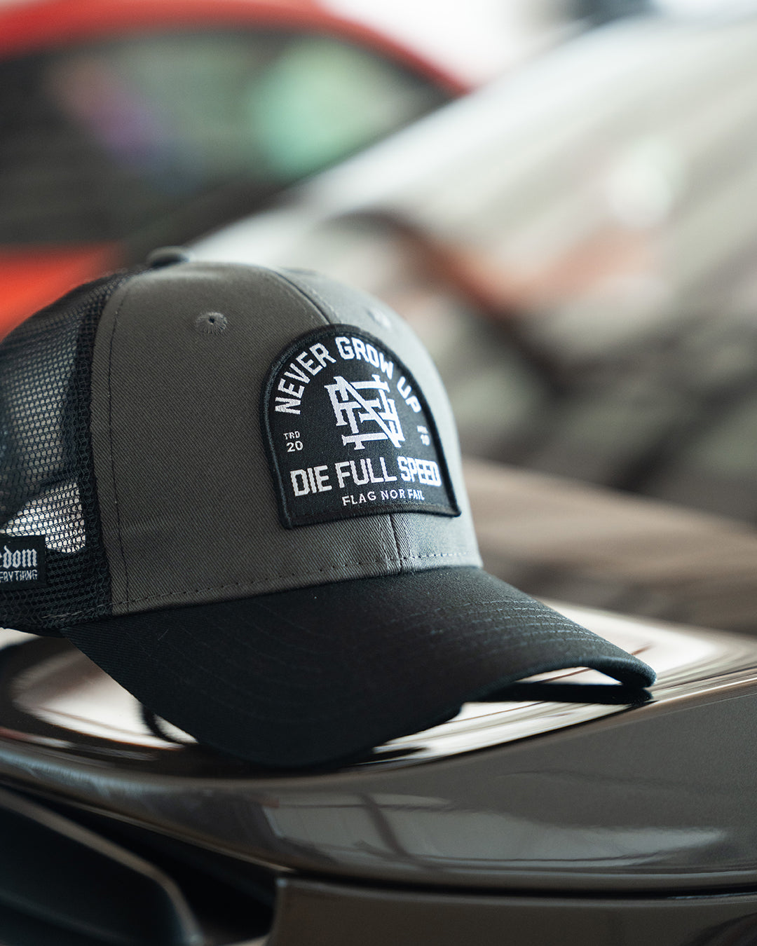 NEVER GROW UP TRUCKER HAT - BLACK