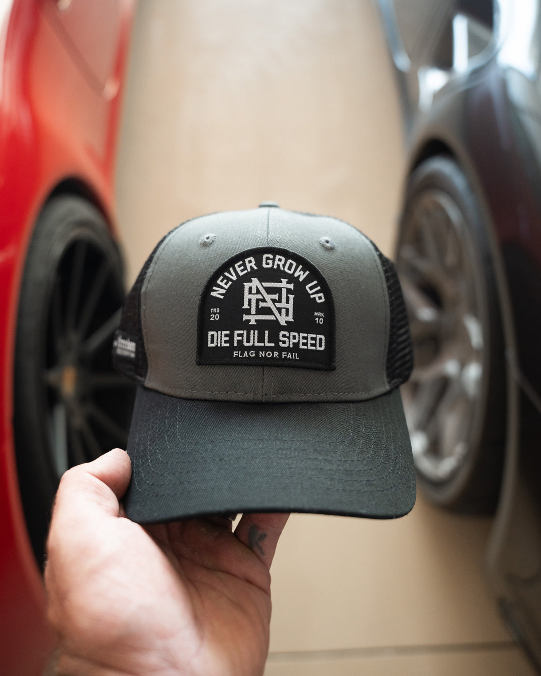 NEVER GROW UP TRUCKER HAT - BLACK