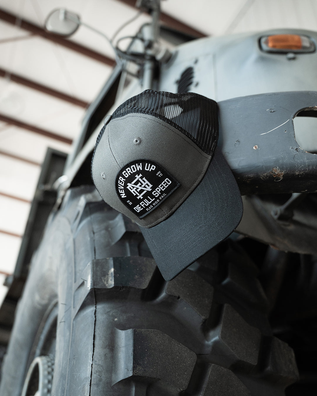 NEVER GROW UP TRUCKER HAT - BLACK