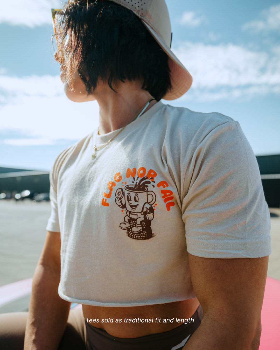 Person wearing a white t-shirt with a graphic design outdoors