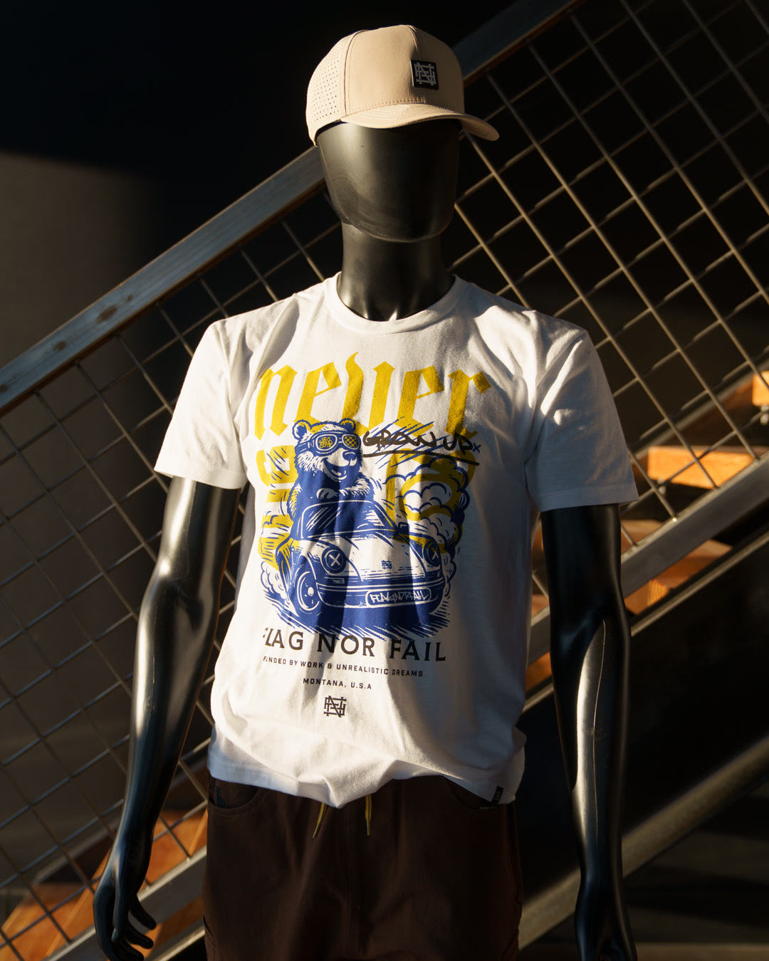 Mannequin wearing a white t-shirt with graphic design and text, standing against a dark background.