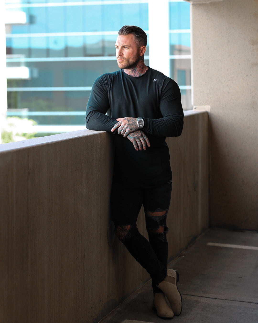 Man leaning against a wall in an urban setting