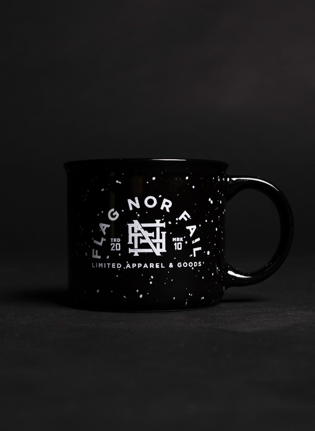 Ceramic mug. Black in color with white speckles. Featuring a white Flag nor Fail logo.